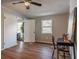 Bedroom showcasing wood floors, a ceiling fan, and a large sliding door closet at 516 Richards Rd, White, GA 30184