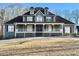 Two-story house with wrap-around porch, gray siding, and red shutters at 447 Cotton Mill Dr, Hiram, GA 30141