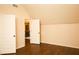 Spacious attic room with wood flooring and a view of the upstairs hallway at 7940 White Oak Loop, Lithonia, GA 30038