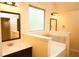 Bright bathroom with marble countertop, bathtub, and elegant vanity lights adding to the home's appeal at 7940 White Oak Loop, Lithonia, GA 30038