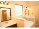Bright bathroom with marble countertop, bathtub, and elegant vanity lights adding to the home's appeal at 7940 White Oak Loop, Lithonia, GA 30038