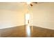 Bright bedroom with ceiling fan, hardwood floors, and open doors leading to a closet at 7940 White Oak Loop, Lithonia, GA 30038