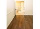 Bedroom featuring hardwood flooring, with an open door showcasing the home's neutral color palette at 7940 White Oak Loop, Lithonia, GA 30038