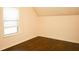 A cozy bedroom with a window letting in natural light, and hardwood floors at 7940 White Oak Loop, Lithonia, GA 30038