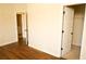 Bedroom with wood-look floors, neutral walls, and closet access at 7940 White Oak Loop, Lithonia, GA 30038