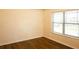A well-lit bedroom with wood-look floors and a window at 7940 White Oak Loop, Lithonia, GA 30038
