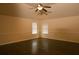 Spacious bedroom with ceiling fan, hardwood floors, and natural light at 7940 White Oak Loop, Lithonia, GA 30038