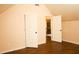 Bright bedroom with hardwood floors, and open doors leading to the rest of the house at 7940 White Oak Loop, Lithonia, GA 30038