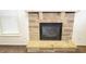 Close-up of stone fireplace with hearth, providing a cozy focal point at 7940 White Oak Loop, Lithonia, GA 30038