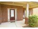 Inviting front porch with brick columns and space for seating, offering a warm welcome at 7940 White Oak Loop, Lithonia, GA 30038