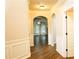 Hallway with hardwood floors, arched doorways, and classic trim at 7940 White Oak Loop, Lithonia, GA 30038