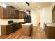 Well-lit kitchen with dark cabinetry, granite countertops, a kitchen island, and modern black appliances at 7940 White Oak Loop, Lithonia, GA 30038