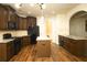 Open kitchen featuring granite countertops, dark wood cabinetry, and stainless steel appliances at 7940 White Oak Loop, Lithonia, GA 30038