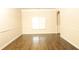 A bright living room features hardwood floors, wainscoting and a large window at 7940 White Oak Loop, Lithonia, GA 30038