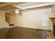 Spacious living room with hardwood floors, trey ceiling, chandelier, and staircase in the background at 7940 White Oak Loop, Lithonia, GA 30038
