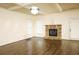 Living room with hardwood floors, trey ceiling, brick fireplace, and access to the patio at 7940 White Oak Loop, Lithonia, GA 30038