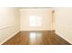 A bright living room with hardwood floors, wainscoting and a large window at 7940 White Oak Loop, Lithonia, GA 30038