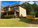 This home offers great curb appeal with a well-kept lawn, brick accents, and a wooden fence at 7940 White Oak Loop, Lithonia, GA 30038