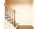 Staircase with hardwood steps, a wood handrail, and black iron balusters at 7940 White Oak Loop, Lithonia, GA 30038