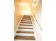View of staircase with hardwood steps and white risers leading upstairs at 7940 White Oak Loop, Lithonia, GA 30038