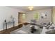 Living area with gray sectional sofa and hardwood floors at 2076 W Flat Shoals Ter, Decatur, GA 30034