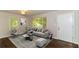 Living room with gray sectional sofa and hardwood floors at 2076 W Flat Shoals Ter, Decatur, GA 30034