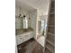 Bathroom with a large mirror and storage shelves at 4345 Wellington Pl, Cumming, GA 30040