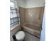 Bathroom features a tiled floor, neutral color scheme, and a shower-tub combination at 4345 Wellington Pl, Cumming, GA 30040