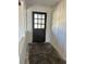 Entryway features a white-paneled wall, a glass-paned door, and a dated floor at 4345 Wellington Pl, Cumming, GA 30040