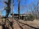 House with a deck in a wooded setting at 4345 Wellington Pl, Cumming, GA 30040