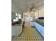 Spacious kitchen area features a vintage ceiling fan, and black and yellow tile floor at 4345 Wellington Pl, Cumming, GA 30040
