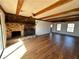 Living room features a large stone fireplace, hardwood floors, and exposed beams at 4345 Wellington Pl, Cumming, GA 30040