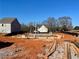 New home construction with foundation and framing underway at 112 Winsome Way, Woodstock, GA 30188