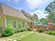 Charming home featuring a well-manicured lawn, stone pathway, and a cozy covered patio for outdoor relaxation at 192 Chicopee Ne Dr, Marietta, GA 30060