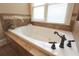 This bathroom has a large soaking tub with bronze fixtures and decorative tiling around the tub at 192 Chicopee Ne Dr, Marietta, GA 30060