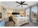 This carpeted bedroom features two bedside tables, a ceiling fan, and a large window for natural light at 192 Chicopee Ne Dr, Marietta, GA 30060