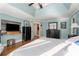 This main bedroom features a mounted TV, hardwood floors and a decorative tray ceiling at 192 Chicopee Ne Dr, Marietta, GA 30060