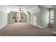 This carpeted bonus room has light green walls and a dormer window with decorative art hanging near it at 192 Chicopee Ne Dr, Marietta, GA 30060
