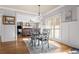 Dining room with wainscoting, decorative chandelier, hardwood floors, and open to living room at 192 Chicopee Ne Dr, Marietta, GA 30060