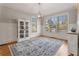 Dining room with hardwood floors, cabinet with glass doors, and large windows with blinds at 192 Chicopee Ne Dr, Marietta, GA 30060