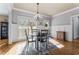 Dining room featuring a chandelier, windows with natural light, and decorative wainscoting at 192 Chicopee Ne Dr, Marietta, GA 30060