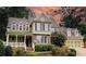 Two-story house with brick and green siding, a large front porch, and a two-car garage at 192 Chicopee Ne Dr, Marietta, GA 30060