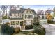Inviting two-story home with light green siding, brick accents, covered porch, and attached garage at 192 Chicopee Ne Dr, Marietta, GA 30060
