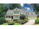 Two-story house with brick and green siding, a large front porch, and a two-car garage at 192 Chicopee Ne Dr, Marietta, GA 30060