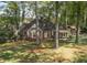 Traditional brick home nestled among mature trees, featuring a well-manicured lawn and inviting curb appeal at 192 Chicopee Ne Dr, Marietta, GA 30060