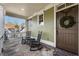 Inviting front porch with stone flooring, rocking chairs, and a decorative wreath on the wooden front door at 192 Chicopee Ne Dr, Marietta, GA 30060