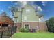Back of house with brick, green siding, a deck, and a fenced backyard at 192 Chicopee Ne Dr, Marietta, GA 30060
