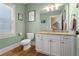 Light-filled powder room with granite countertop and white cabinets at 192 Chicopee Ne Dr, Marietta, GA 30060