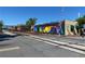 A railroad crossing with colorful building murals and a crossing sign under a clear blue sky at 192 Chicopee Ne Dr, Marietta, GA 30060