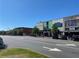 Street view featuring businesses and shops, captured on a sunny day with cars parked along the road at 192 Chicopee Ne Dr, Marietta, GA 30060